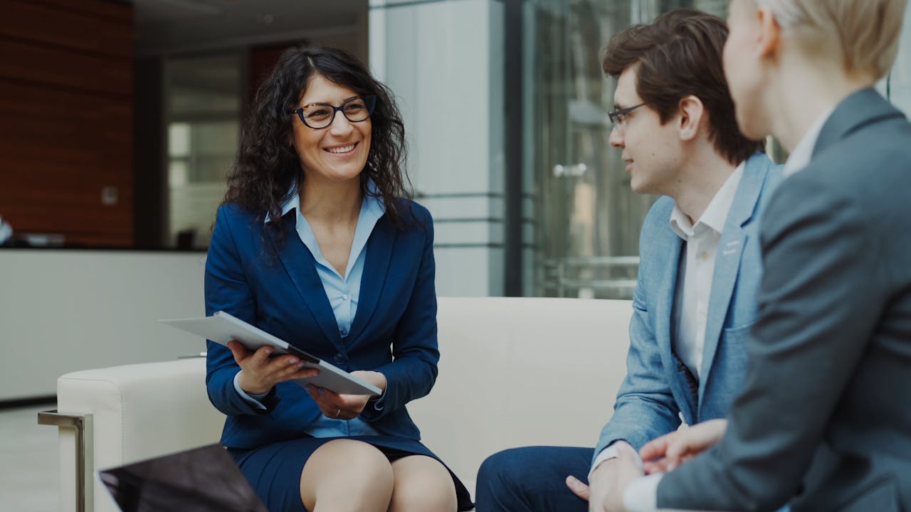 testimonials-img Professionals discussing business strategy in a corporate office setting.